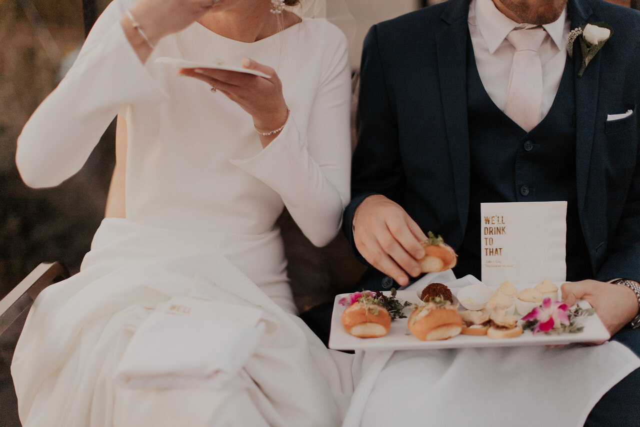 Bride and groom enjoying finger food.