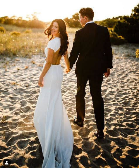 A newly wed couple on a beach.