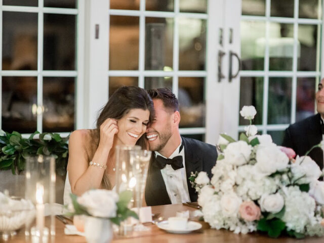 A bride and groom smiling.