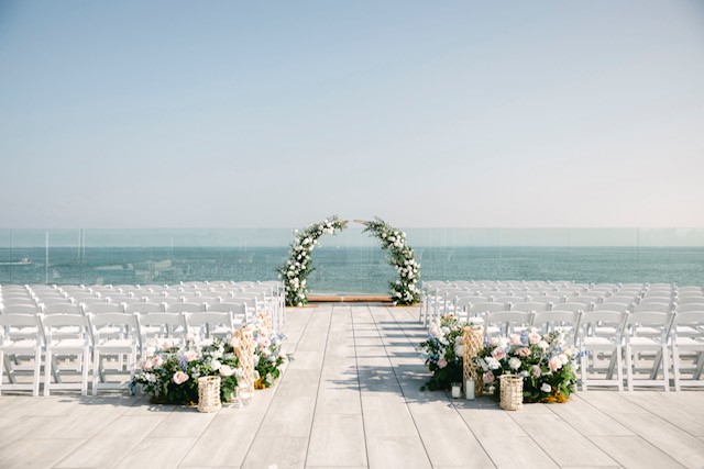 An outdoor deck set up for a wedding ceremony.